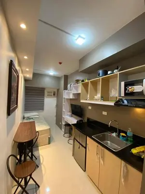 a kitchen with a sink and a table in a room at Aral Realty and Property Management in Manila