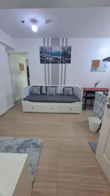 a living room with a couch in a room at AZURE BICUTAN BACKPACKERS MAUI Tower in Manila