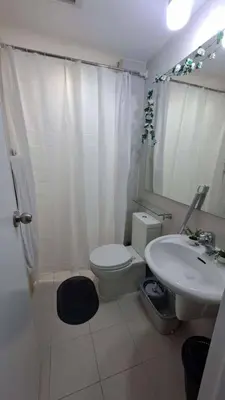 a bathroom with a white toilet and a sink at AZURE BICUTAN BACKPACKERS MAUI Tower in Manila