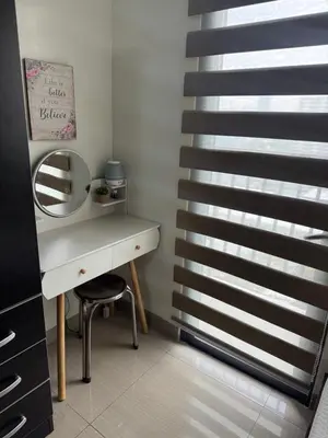 a bathroom with a dressing table and a mirror at Newly Furnished Staycation near Mall of Asia in Manila