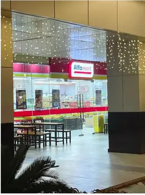 a restaurant with tables and a sign in a building at Newly Furnished Staycation near Mall of Asia in Manila