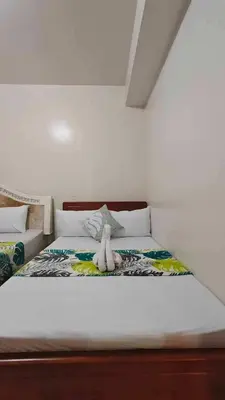 a bed with a stuffed animal sitting on top of it at 1148a 3br 1-king size 1queen size 2 double size 2-single size 1-extra matress Moa view in Manila