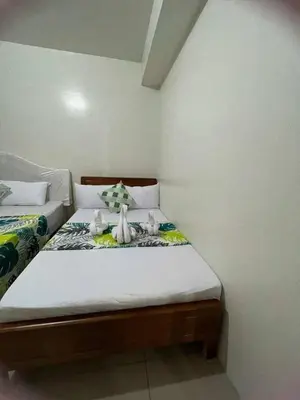 a bedroom with a bed with two stuffed animals on it at 1148a 3br 1-king size 1queen size 2 double size 2-single size 1-extra matress Moa view in Manila