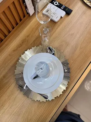 a white plate on a table with a glass at Relax in Pasay Citys Best Kept Secret - Spacious Condo with Garden View in Manila