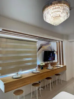 a room with a large window with a table and stools at Relax in Pasay Citys Best Kept Secret - Spacious Condo with Garden View in Manila