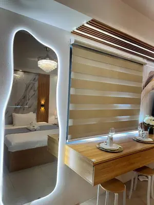 a bedroom with a bed and a table and chairs at Relax in Pasay Citys Best Kept Secret - Spacious Condo with Garden View in Manila
