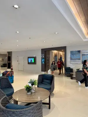 a lobby with couches and chairs and a table at Relax in Pasay Citys Best Kept Secret - Spacious Condo with Garden View in Manila