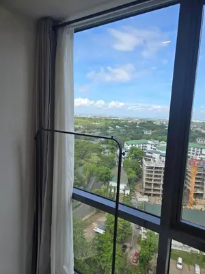 a window with a view of a city at Cozy Corner Studio in McKinley Walk to Venice Mall in Manila