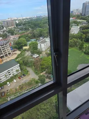 a view of a city from a window at Cozy Corner Studio in McKinley Walk to Venice Mall in Manila