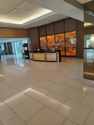 a lobby with a large tile floor in a building at Shell Residences MOA 2 beds by Dad's in Manila