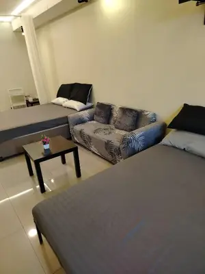 a living room with two beds and a couch at Shell Residences MOA 2 beds by Dad's in Manila