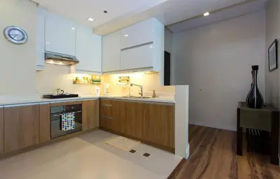 a kitchen with a sink and a stove top oven at Elegant 2BR Apartment in Upscale Fort BGC Fast Wifi in Manila