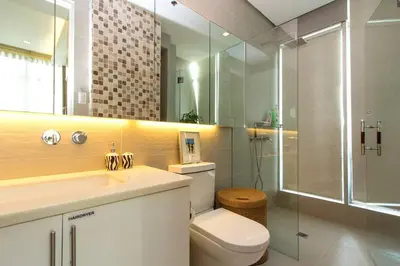 a bathroom with a toilet and a sink and a shower at Elegant 2BR Apartment in Upscale Fort BGC Fast Wifi in Manila