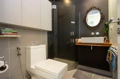 a bathroom with a white toilet and a mirror at Elegant 2BR Apartment in Upscale Fort BGC Fast Wifi in Manila