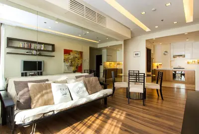 a living room with a couch and a dining room at Elegant 2BR Apartment in Upscale Fort BGC Fast Wifi in Manila