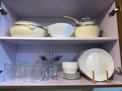 a shelf filled with plates and bowls and glasses at Bayfront Staycation at The Radiance Manila Pet-Friendly, Free Pool & Gym near Airport, MOA, Star City, Manila World Trade Center & Manila Bay in Manila