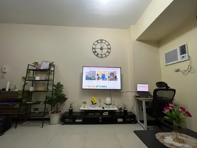 an office with a clock on the wall and a desk at Bayfront Staycation at The Radiance Manila Pet-Friendly, Free Pool & Gym near Airport, MOA, Star City, Manila World Trade Center & Manila Bay in Manila