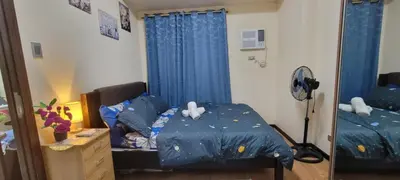 a bedroom with a bed with a blue comforter at Bayfront Staycation at The Radiance Manila Pet-Friendly, Free Pool & Gym near Airport, MOA, Star City, Manila World Trade Center & Manila Bay in Manila