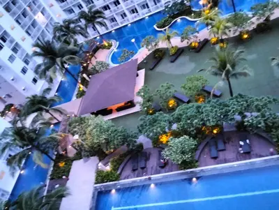 an overhead view of a building with trees and a swimming pool at Ellein's Crib At Moa in Manila