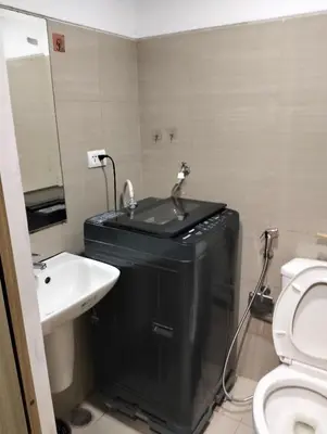 a bathroom with a sink and a toilet at Ellein's Crib At Moa in Manila