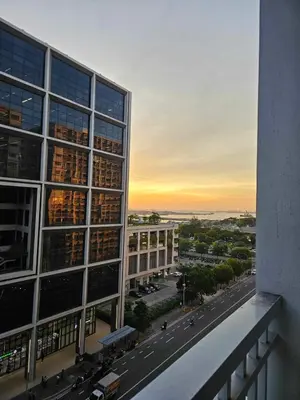 a view of a building from the balcony of a building at Spacious 1BR beside MOA with Wifi, Netflix, Pool & Washer in Manila