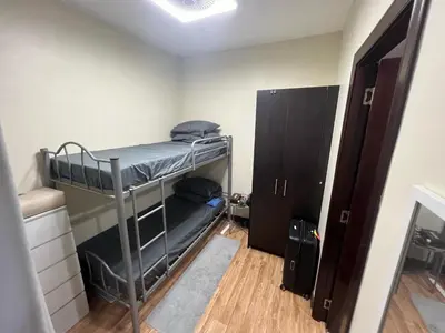 a small room with a bunk bed and a closet at Staycation Alabang by Larsen in Manila