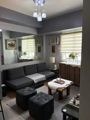 a living room with a couch and a table at Amaia skies cubao in Manila