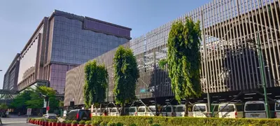 a large building with trees in front of it at Your Home at One Palm Tree Villas near NAIA T3 in Manila