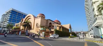 a building on the side of a street next to a building at Your Home at One Palm Tree Villas near NAIA T3 in Manila