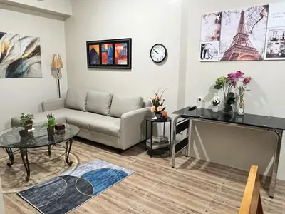a living room with a couch and a table at Altitude Abode at Eighty One Across NAIA 3 in Metro Manila in Manila