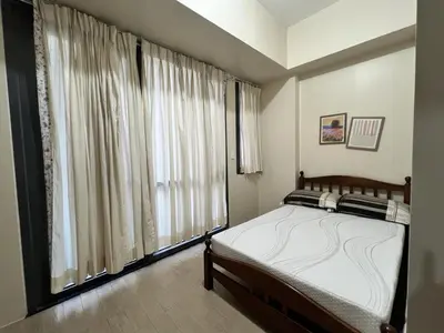 a bedroom with a bed and a large window at Altitude Abode at Eighty One Across NAIA 3 in Metro Manila in Manila