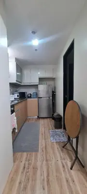 a kitchen with a table and a chair in a room at Altitude Abode at Eighty One Across NAIA 3 in Metro Manila in Manila