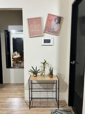 a room with a table with plants on a wall at Altitude Abode at Eighty One Across NAIA 3 in Metro Manila in Manila