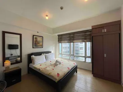 a bedroom with a bed with a teddy bear on it at Tiny home near NAIA Terminal 3 in Manila