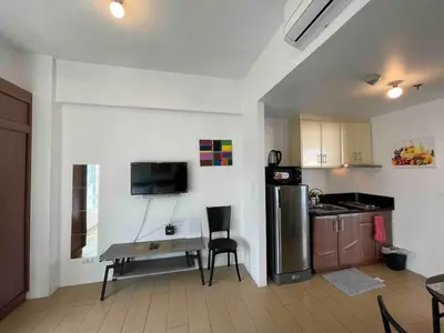 a kitchen with a small table and a refrigerator at Tiny home near NAIA Terminal 3 in Manila