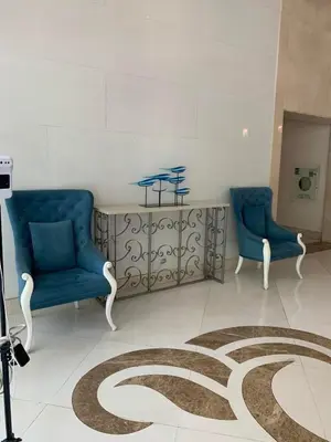 a room with two blue chairs and a carpet at Tiny home near NAIA Terminal 3 in Manila