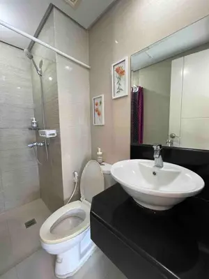 a bathroom with a sink and a toilet and a mirror at Tiny home near NAIA Terminal 3 in Manila