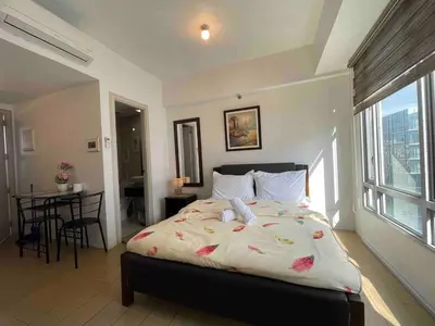 a bedroom with a bed with flowers on it at Tiny home near NAIA Terminal 3 in Manila
