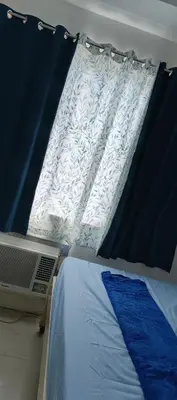 a bedroom with a bed and a window with a bed sqor at SEA RESIDENCES STAYCATION near MOA by Mae in Manila