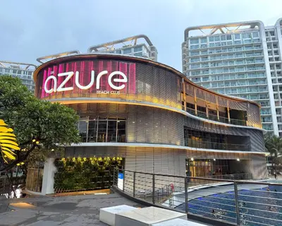 a building with a sign on the side of it at Cozy Green 1 BR unit with Balcony Azure Bahamas South in Manila