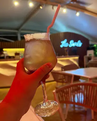 a person holding up a drink with a straw at Cozy Green 1 BR unit with Balcony Azure Bahamas South in Manila