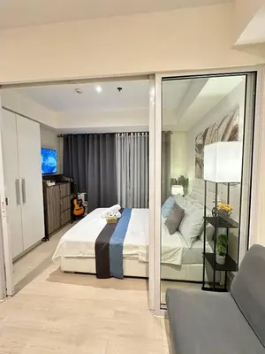 a bedroom with a bed and a sliding glass door at 1BR Condotel in Azure Urban Resort Near NAIA #BH1 in Manila