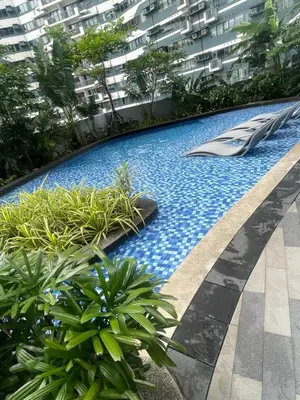 a swimming pool in the middle of a building at Air Residences staycation2 in Manila