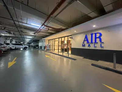 an empty parking garage with an air max sign on the wall at Air Residences staycation2 in Manila