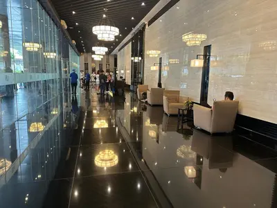a lobby with people sitting in chairs in a building at Air Residences staycation2 in Manila