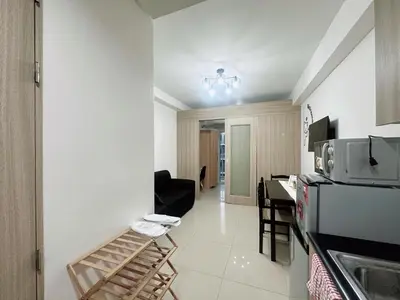 a kitchen with a counter and a table in a room at Shore Stay in Manila