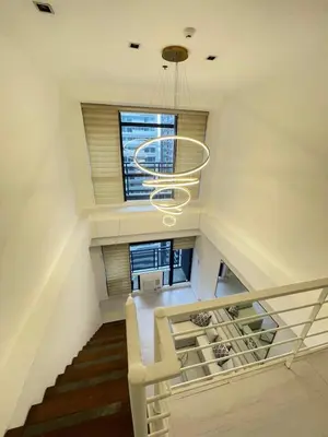 a stairway with a spiral staircase in a house at Minimalist 1 Bedroom Loft Makati in Gramercy Residences in Manila