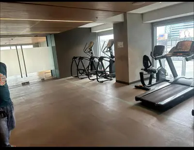 a gym with several treadmills and exercise bikes at A peace crib Eastwood in Manila