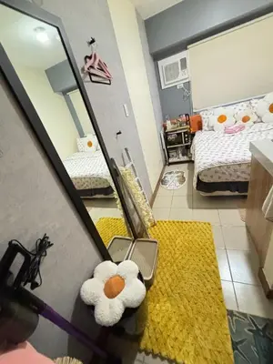 a room with two beds and a mirror with a teddy bear at Columbres Place in Manila