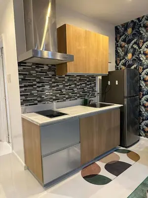a kitchen with a sink and a stove at Modern Studio with Balcony in The Gramercy Residences in Manila
